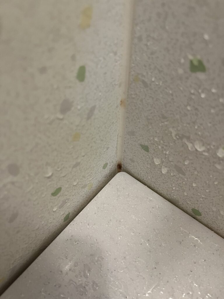 壁の角に残った小さな赤サビ